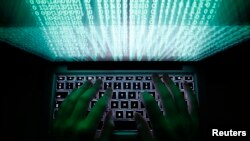 FILE - A man types on a computer keyboard in Warsaw (Reuters) 