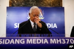 Malaysian Prime Minister Najib Razak, center, gestures before speaking at a special press conference announcing the findings for the ill fated flight MH370 in Kuala Lumpur, Malaysia, Aug. 6, 2015.