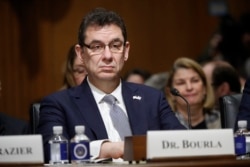 FILE - In this Feb. 26, 2019 file photo, Albert Bourla, chief executive officer of Pfizer, prepares to testify before the Senate in Washington, DC.