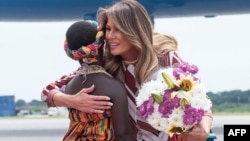 US first lady Melania Trump receives flowers during an arrival ceremony after landing at Kotoka International Airport in Accra October 2, 2018 as she begins her week long trip to Africa to promote her 'Be Best' campaign.