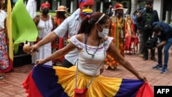Followers of San Juan Bautista, known as "San Juaneros," dance during a ceremony to celebrate after UNESCO recognized the Festive cycle around the devotion and worship of Saint John the Baptist, as Intangible Cultural Heritage of Humanity, in Caracas, Venezuela, Dec. 14, 2021. 