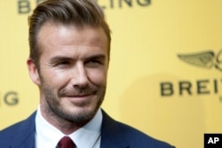 FILE - English former footballer David Beckham poses for photographers.
