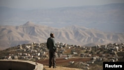 Jewish settler Refael Morris stands at an observation point overlooking the West Bank village of Duma, near Yishuv Hadaat, an unauthorized Jewish settler outpost January 5, 2016.