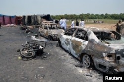 Burnt out cars and motorcycles are seen at the scene of an oil tanker explosion in Bahawalpur, Pakistan, June 25, 2017.