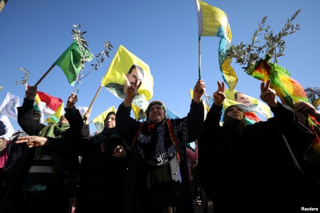 People gesture during a protest against the Turkish attacks on Afrin in Qamishli, Syria, Jan. 30, 2018.