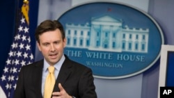 FILE- White House Press Secretary Josh Earnest answers a question during the daily press briefing at the White House in Washington.