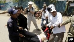 A Cambodian protester from Boueng Kak lake is carried by police officers while demonstrating near the area where she owned a home, in Phnom Penh. At least two women were arrested by local authorities while demanding compensation for being evicted from the