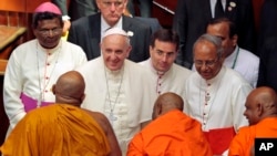 Pope Francis smiles as he speaks to Buddhist monks after an inter-religious meeting in Colombo, Sri Lanka, Tuesday, Jan. 13, 2015.