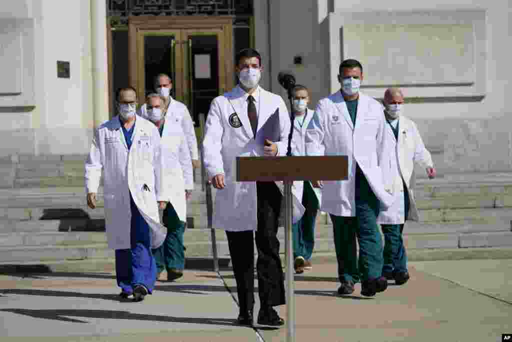 Dr. Sean Conley, physician to President Donald Trump, center, and other doctors, walk out to talk with reporters at Walter Reed National Military Medical Center, Monday, Oct. 5, 2020, in Bethesda, Md. (AP Photo/Evan Vucci)