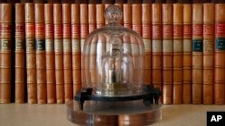 FILE - A replica of the International Prototype Kilogram is pictured at the International Bureau of Weights and Measures, in Sevres, near Paris, Oct. 17, 2018.