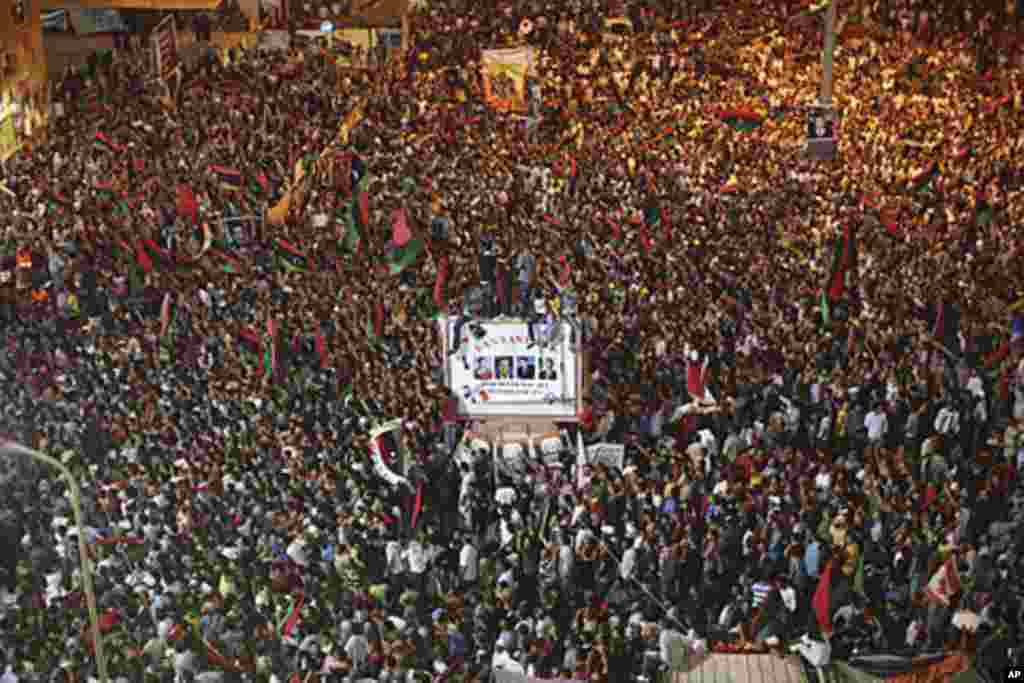 People celebrate the capture in Tripoli of Moammar Gadhafi's son, Seif al-Islam, in the rebel-held town of Benghazi, Libya, early Monday, Aug. 22, 2011. (AP)