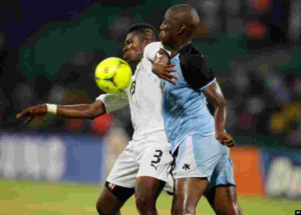 Ghana's Gyan challenges Ananan of Botswana during their African Cup of Nations Group D soccer match in FranceVille Stadium