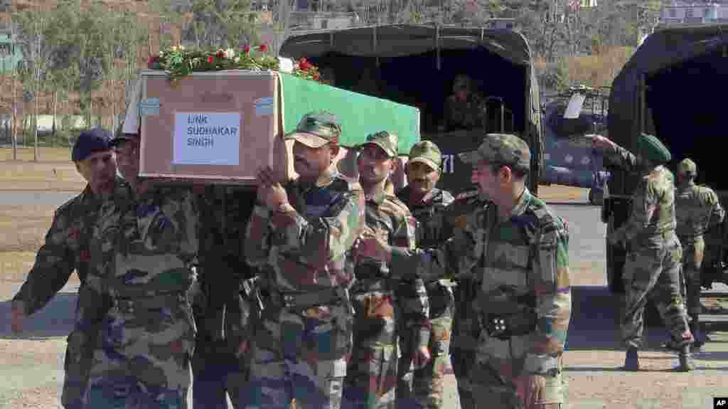 Indian Army soldiers carry a coffin containing the body of a colleague who was allegedly killed by Pakistani soldiers, Rajouri, India, January 9, 2013.