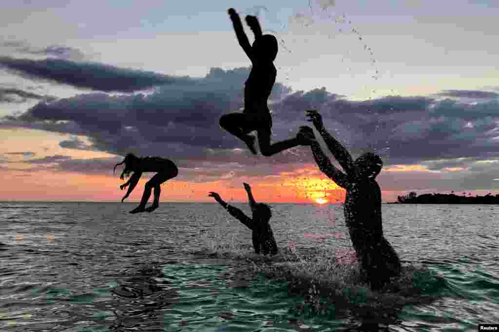 People have fun on a beach during sunset at Ko Kut island in Trat Province, Thailand, Oct. 27, 2018.