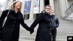 Sandy Stier, left, and Kris Perry of Berkeley, Calif., arrive at the National Archives in Washington, March 25, 2013, to view the U.S. Constitution, a day before their same-sex marriage case is argued before the Supreme Court.