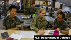 FILE - A U.S. Army captain learns a few Korean terms from two Korean Army soldiers during the 2016 Ulchi Freedom Guardian exercises in Yongin, South Korea, Aug. 25, 2016.