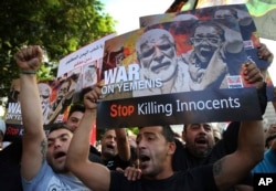 FILE - Lebanese supporters of the Iranian-backed Hezbollah group hold placards and shout slogans against Saudi Arabia and the U.S., during a protest to show their solidarity with Yemen's Shi’ite rebels, known as Houthis, in front the United Nations headquarters, in Beirut, Lebanon, Oct. 10, 2016.