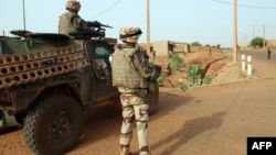 Troops of the French-led Serval Operation in Mali patrol an area in Gao, Oct.16, 2013.