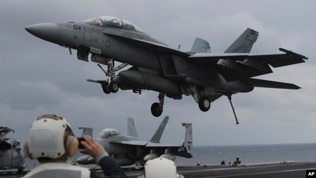 FILE - A U.S. Navy's F/A-18 Super Hornet fighter approaches the deck of the USS Carl Vinson during a joint military exercise between South Korea and the United States, March 14, 2017.