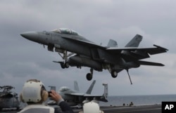 FILE - A U.S. Navy F/A-18 Super Hornet fighter approaches the deck of the Nimitz-class aircraft carrier USS Carl Vinson during the annual joint military exercise between South Korea and the United States, March 14, 2017.