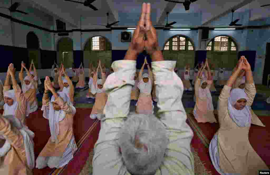 Muslim girls attend a yoga lesson at a school in Ahmedabad, India.