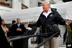 FILE - President Donald Trump answers questions from members of the media as he leaves the White House, Nov. 17, 2018, in Washington.