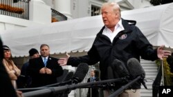 President Donald Trump answers questions from reporters as he leaves the White House, Nov. 17, 2018, in Washington, en route to see fire damage in California. 