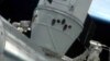 The Canadarm 2 on the International Space Station (ISS) holds the SpaceX Dragon capsule in place after docking/'berthing' with the ISS, May 25, 2012.