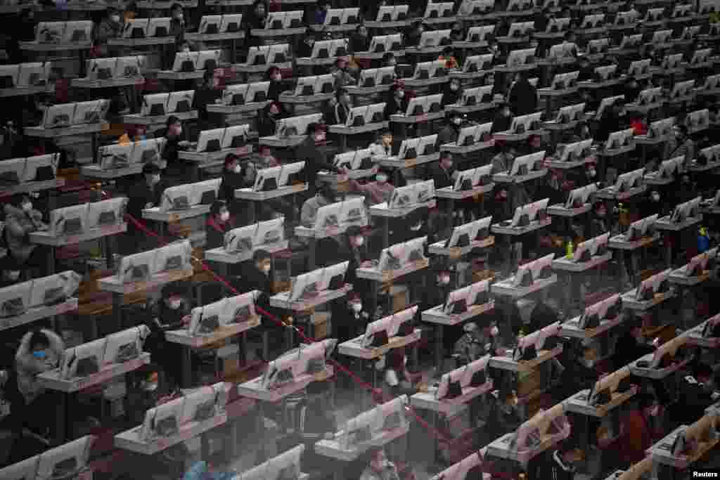 Traders wearing face masks are seen on the trading floor at a flower auction trading center following an outbreak of the novel coronavirus in the country, in Kunming, Yunnan province, China, Feb. 10, 2020.