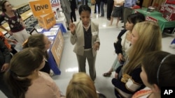 This Oct. 9, 2012, photo shows Utah Republican candidate Mia Love talking with students during the Granite PTA meet the candidates at Skyline High School in Salt Lake City.
