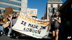 Activists march during a 'climate strike' demonstration in London, Sept. 24, 2021. Britain is set to host the 2021 United Nations Climate Change Conference this November.