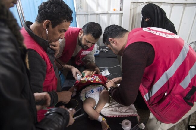 Syrian medics treat a baby at a makeshift clinic at the internally displaced persons camp of al-Hol in al-Hasakah governorate in northeastern Syria, Feb. 6, 2019.