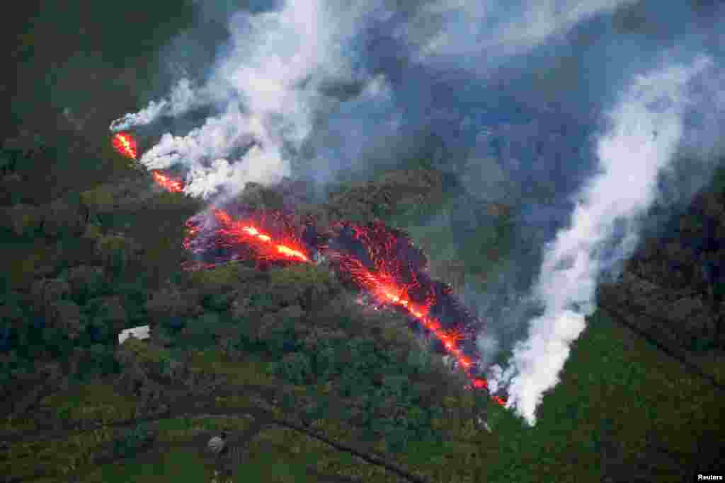 Lava comes out of a crack in the earth, east of the Leilani Estates neighborhood, during the ongoing eruption of the Kilauea Volcano in Hawaii, May 13, 2018.