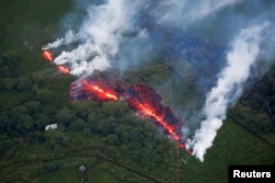 FILE - Lava erupts from a fissure east of the Leilani Estates subdivision during ongoing eruptions of the Kilauea volcano in Hawaii, May 13, 2018.