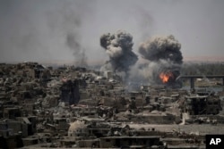 Airstrikes target Islamic State positions on the edge of the Old City a day after Iraq's prime minister declared "total victory" in Mosul, Iraq, July 11, 2017.