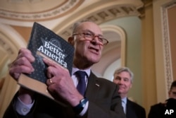 Senate Democratic leader Chuck Schumer of New York, joined at right by Sen. Sheldon Whitehouse, D-R.I., criticizes President Donald Trump's budget proposals during a news conference at the Capitol in Washington, March 12, 2019. Titled "A Budget for a Better America: Promises Kept. Taxpayers First," Schumer called it "promises broken."