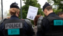 Police officers block demonstrators as they try to reach the headquarter of French media BFM during a national day of protest against the compulsory use of the health pass called for by the French government in Paris on July 31, 2021.