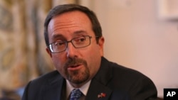 U.S. Ambassador John Bass says the political tensions are only benefiting terrorists and enemies of Afghanistan.