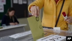 တူရကီရွေးကောက်ပွဲ အတွင်း မဲဆန္ဒရှင်တဦး မဲထည့်နေစဉ် 