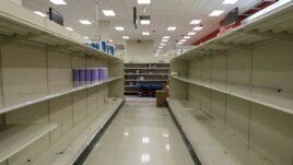 Shelves stand emptied by customers at a local retail store, Monday, March 16, 2020 in New York. New York state entered a new phase in the coronavirus pandemic Monday with all of New York City's public schools closed. (AP Photo/Yuki Iwamura)