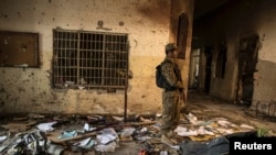 An army soldier stands in the Army Public School, which was attacked by Taliban gunmen, in Peshawar, Dec. 17, 2014. Taliban gunmen in Pakistan took hundreds of students and teachers hostage. More than 140 people died in the massacre. Umar Mansoor was reportedly the mastermind behind the attack. 