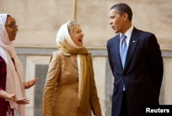 FILE - President Barack Obama and then-Secretary of State Hillary Clinton tour the Sultan Hassan Mosque in Cairo, June 4, 2009.