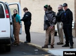 A woman is taken into police custody outside an anti-Dakota Access Pipeline protest at Kirkwood Mall in Bismarck, North Dakota, Nov. 25, 2016.