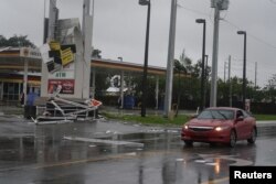 A gas station sign lays destroyed after Hurricane Irma blew though Fort Lauderdale, Florida, Sept.10, 2017.