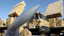 Iran says the Bavar-373 is a long-range surface-to-air missile system able to recognize up to 100 targets at a same time and confront them with six different weapons. (Iranian Presidency Office via AP)