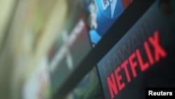 FILE - The Netflix logo is pictured on a television in this illustration photograph taken in Encinitas, Calif., Jan. 18, 2017. 
