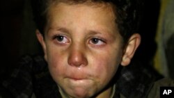  A young boy waits to be evacuated from the besieged town of Madaya, northwest of Damascus, Syria, on Jan. 11, 2016.