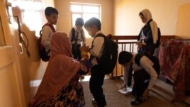Golshan, a childcare worker, gets the children ready for school at the orphanage in Kabul, Afghanistan, October 12, 2021. REUTERS/Jorge Silva