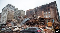 A pile of debris remains at the site of a building explosion in the East Village neighborhood of New York, Friday, March 27, 2015.