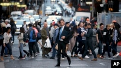 Pedestrians cross a road in Sydney, Australia, Sept. 6, 2017.